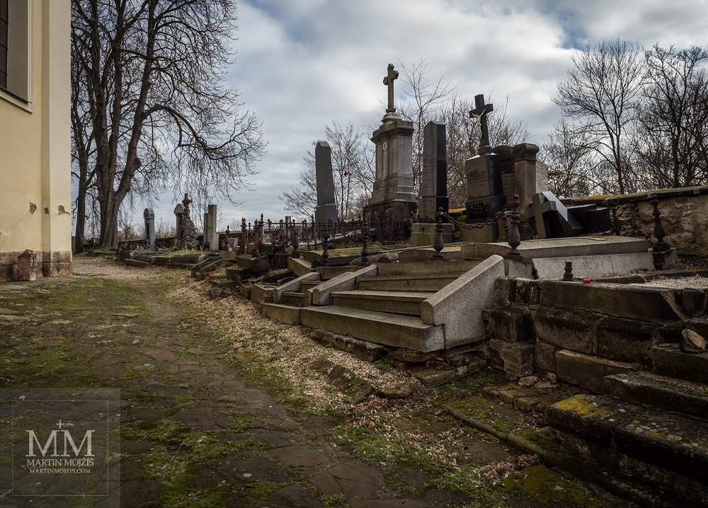 Cemetery by the church. Photograph created with Olympus 12 - 40 mm 2.8 Pro lens.